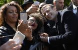 French newly elected president Emmanuel Macron (R) poses for pictures with supporters on May 10, 2017 at the Jardins du Luxembourg in Paris during a ceremony to mark the anniversary of the abolition of slavery and to pay tribute to the victims of the slave trade. / AFP PHOTO / POOL AND AFP PHOTO / Eric FEFERBERG